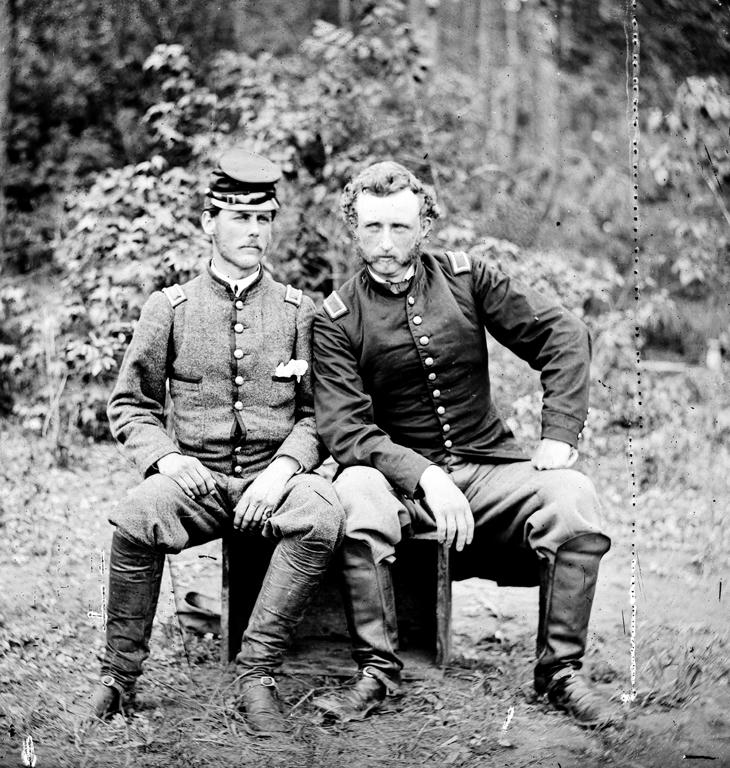 Custer sits with a prisoner of war