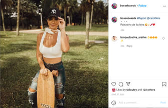 Female person passively holding a skateboard